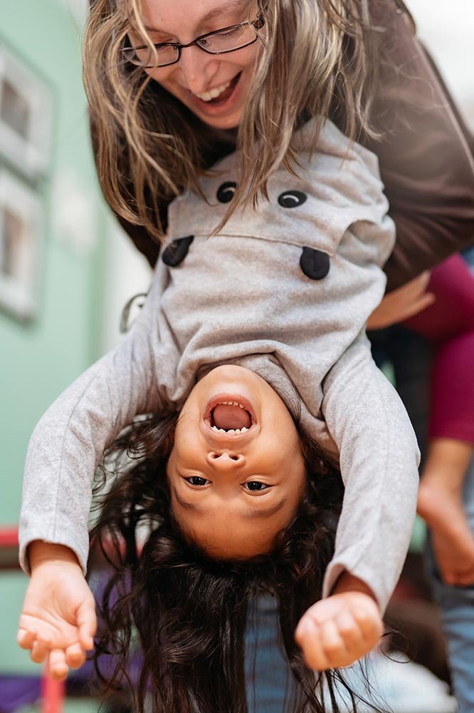 woman-holding-child-upside-down-both-smiling-2026-01-05-23-20-27-utc.jpg